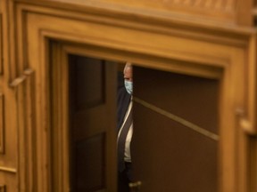 Ontario Premier Doug Ford is seen behind a closing door in a back room at the Queen's Park Legislature in Toronto on Monday, June 14, 2021.