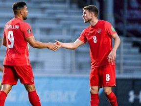 Canada striker Lucas Cavallini, (No. 9) is congratulated by teammate David Wotherspoon (No. 8) after scoring against Aruba in a FIFA 2022 World Cup Qualifying match in Bradenton, Fla., on June 5, 2021. Canada won 7-0.