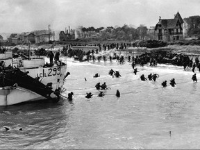 Canadian troops wade ashore to the beaches of Normandy early on the morning of June 6, 1944. The D-Day invasion of France.