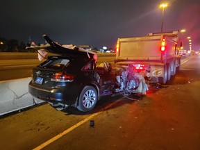 A vehicle is barely recognizable after it slammed into a stopped dump truck in a construction zone on Hwy. 401 near Dufferin St. early Tuesday, June 1., 2021.
