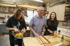 Joeseph Fabrizio of Stouffville Ontario teaches his daughters about woodworking in his shop