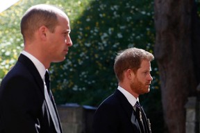 Britain’s Prince William, Duke of Cambridge (L) and Britain’s Prince Harry, Duke of Sussex follow the coffin during the ceremonial funeral procession of Britain’s Prince Philip, Duke of Edinburgh to St George’s Chapel in Windsor Castle in Windsor, west of London, on April 17, 2021.