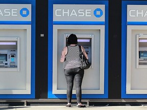 A customer uses an ATM outside of a Chase bank office on October 13, 2011 in Oakland, California.
