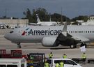 American Airlines jet   pulls away from its gate at Miami International Airport.