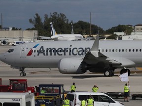 American Airlines jet   pulls away from its gate at Miami International Airport.