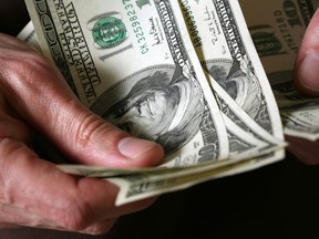 Man's hands hold dollars banknotes money