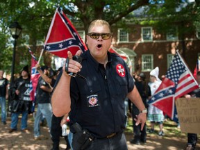 TOPSHOT - A member of the Ku Klux Klan shouts at counter protesters during a rally, calling for the protection of Southern Confederate monuments, in Charlottesville, Virginia on July 8, 2017.
The afternoon rally in this quiet university town has been authorized by officials in Virginia and stirred heated debate in America, where critics say the far right has been energized by Donald Trump's election to the presidency.
 / AFP PHOTO / ANDREW CABALLERO-REYNOLDS        (Photo credit should read ANDREW CABALLERO-REYNOLDS/AFP via Getty Images)