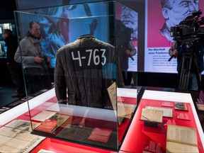 In this Jan. 23, 2018 file photo, a padded jacket, traditionally worn by prisoners in the Soviet Gulag labour camp system, is on display next to a wooden spoon dubbed as "Stalin ladle" at the "Stalin - The Red God" exhibition at the Berlin-Hohenschoenhausen memorial.