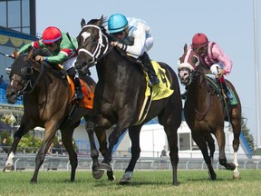 Jockey Gary Boulanger front 
was inducted into the Canadian Horse Racing Hall of Fame last June and suffered a serious knee injury a month later.