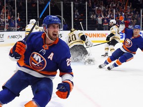 Brock Nelson, left, of the New York Islanders scores against the Boston Bruins at 5:20 of the second period in Game Six of the Second Round of the 2021 NHL Stanley Cup Playoffs at the Nassau Coliseum on June 9, 2021 in Uniondale, N.Y.