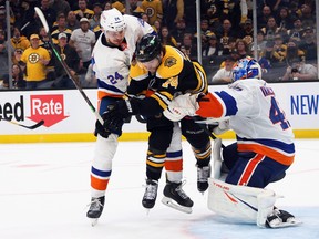 Scott Mayfield and Semyon Varlamov #40 of the New York Islanders defend against Jake DeBrusk during the third period in Game 2 of the Second Round of the 2021 Stanley Cup Playoffs at the TD Garden on May 31, 2021 in Boston, Mass.