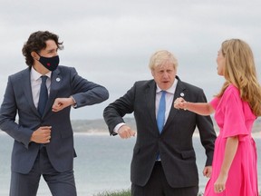 Britain's Prime Minister Boris Johnson (centre) and his wife Carrie Johnson welcome Canada's Prime Minister Justin Trudeau prior to the start of the G7 summit in Carbis Bay, England, Friday, June 11, 2021.