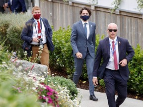 Prime Minister Justin Trudeau walks through the resort during the G7 summit in Carbis Bay, England, Friday, June 11, 2021.