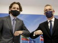 Prime Minister Justin Trudeau and NATO Secretary General Jens Stoltenberg bump elbows as they meet during a NATO summit, at the Alliance's headquarters in Brussels, Belgium, June 14, 2021