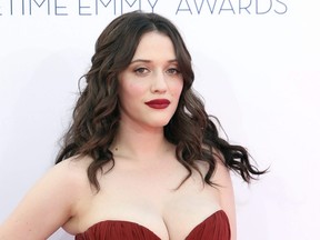 Kat Dennings arrives at the 64th Primetime Emmy Awards at the Nokia Theatre, Sept. 23, 2012, in Los Angeles.