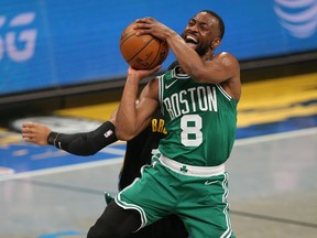 Boston Celtics point guard Kemba Walker (8) is fouled as he shoots at Barclays Center.