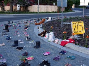 Kenora residents placed shoes and teddy bears at the Park Street roundabout to honour the lives of the 215 fallen children discovered at a residential school near Kamloops, B.C.