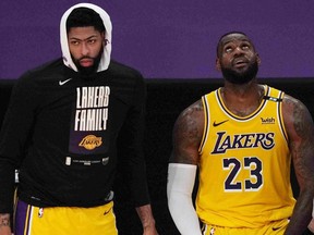 Los Angeles Lakers forward Anthony Davis, left, forward LeBron James react in the second half during Game 6 in the first round of the 2021 NBA Playoffs against the Phoenix Suns at Staples Center in Los Angeles, Calif., June 3, 2021.