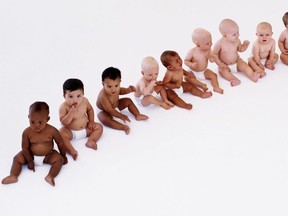 Row of babies (7-12 months) sitting on floor