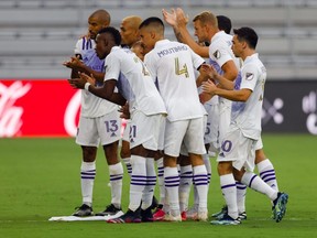 Orlando City players celebrate after their first goal against Toronto FC on June 19, 2021.
