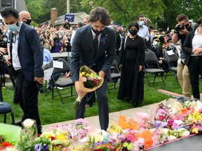 Prime Minister Justin Trudeau places flowers at a vigil outside the London Muslim Mosque organized after four members of a Canadian Muslim family were killed in what police describe as a hate-motivated attack in London, Ont., June 8, 2021.