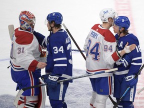 Maple Leafs' Auston Matthews and Mitch Marner shake hands with Montreal goalie Carey Price and Corey Perry after the Canadiens beat the Leafs 3-1 in Game 7 of the first round.
