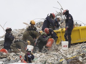 Search and Rescue teams look for possible survivors and to recover remains in the partially collapsed 12-story Champlain Towers South condo building on June 29, 2021 in Surfside, Fla.