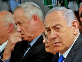 In this file photo taken on September 19, 2019 Israeli Prime Minister Benjamin Netanyahu, right, Israeli president of the Supreme Court Esther Hayut, centre, and Benny Gantz, left, leader of Blue and White party, attend a memorial ceremony for late Israeli president Shimon Peres, at Mount Herzl in Jerusalem.