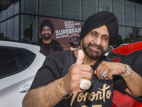 Toronto Raptors Superfan Nav Bhatia with his 2019 championship ring (left) and his hall of fame ring at his Mississauga Hyundai dealership in Mississauga, Ont. on Wednesday, June 2, 2021.