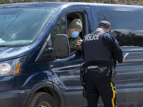A soldier talks with an RCMP officer at a checkpoint in Portapique, N.S. on Thursday, April 23, 2020.