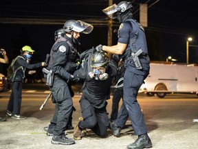 Portland police arrest a protester following a crowd dispersal in front of the Portland Police Association (PPA) building early in the morning on August 29, 2020 in Portland, Oregon.