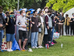 Supporters link arms protecting a homeless encampment at Trinity Bellwoods Park in Toronto on Tuesday, June 22, 2021. ERNEST DOROSZUK/TORONTO SUN
