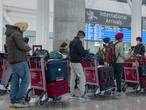 Passengers from New Delhi wait in long lines for transportation to their quarantine hotels at Pearson Airport in Toronto in April.
