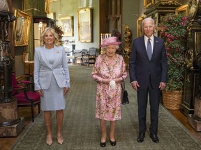 Queen Elizabeth II with U.S. President Joe Biden and First Lady Jill Biden in the Grand Corridor during their visit to Windsor Castle on June 13, 2021 in Windsor, England.