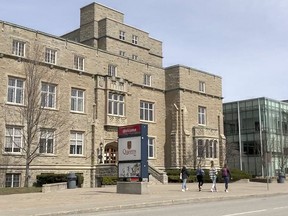 Students walk outside the John Deutsch University Centre on the Queen's University campus in Kingston on Thurs., March 25, 2021.