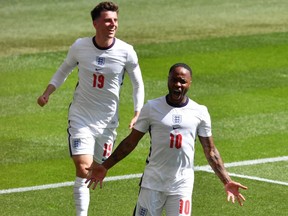England's Raheem Sterling celebrates scoring with Mason Mount against Croatia at Euro 202 in Wembley Stadium on June 13, 2021.