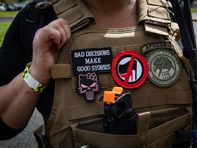 An attendee wears a "Three Percenter" patch during a Proud Boys rally at Delta Park in Portland, Oregon on September 26, 2020.