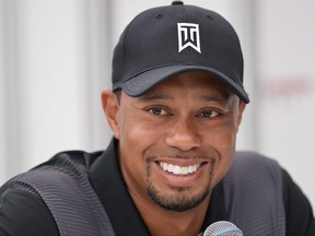 (In this file photo, golfer Tiger Woods smiles while speaking to the press at the Congressional Country Club in Bethesda, Md., on June 24, 2014.