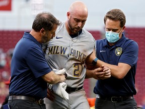 Travis Shaw of the Milwaukee Brewers leaves the game after being injured against the Cincinnati Reds at Great American Ball Park on June 9, 2021 in Cincinnati.