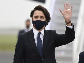 Prime Minister Justin Trudeau waves as he arrives ahead of the G7 meeting at Cornwall airport on June 10, 2021 in Newquay, England.