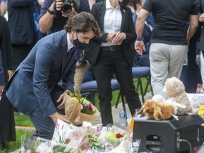 Prime Minister Justin Trudeau lays flowers at the London Mosque prior to a Tuesday a vigil being held in memory of the Afzaal-Salman family. Four members of the family were killed Sunday in what police allege was a hate-motivated attack.