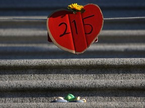 Shoes, teddy bears and messages are displayed on the steps outside the legislature in Victoria, Tuesday, June 1, 2021, in honour of the 215 residential school children whose remains have been discovered buried near the facility in Kamloops, B.C.