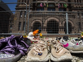 Following the discovery of the remains of 215 children found buried on the site of a former residential school in Kamloops, B.C., shoes are placed at the front entrance of Queen's Park in Toronto on Monday, May 31, 2021.