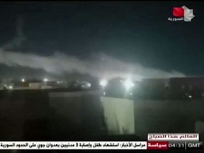 In this image grab taken from a broadcast by Syria TV on Monday, June 28, 2021, shows smoke billowing from a facility used by Iran-backed groups following U.S. air strikes on the Syrian-Iraqi border.