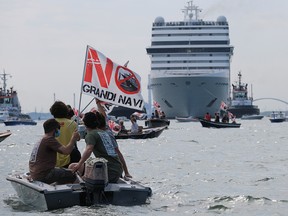 Venice residents sit on boats as they protest to demand an end to cruise ships passing through the lagoon city, as the first cruise ship of the summer season departs from the Port of Venice, Italy, June 5, 2021.