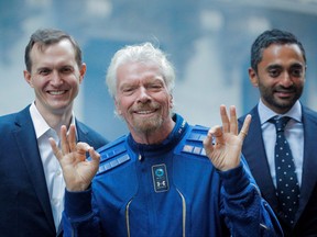 Virgin Galactic co-founder Sir Richard Branson, CEO George Whitesides and Social Capital CEO Chamath Palihapitiya pose together outside of the New York Stock Exchange n New York, Oct. 28, 2019.