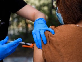 In this file photo, a 15-year-old receives a first dose of the Pfizer COVID-19 vaccine at a mobile vaccination clinic at the Weingart East Los Angeles YMCA on May 14, 2021 in Los Angeles, Calif.
