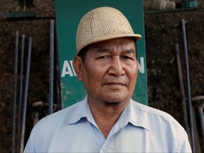 Ziona, 67, poses for a picture at the construction site of a church in Baktawng village in the northeastern Indian state of Mizoram, Oct. 5, 2011.