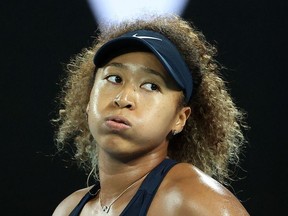 This file photo taken on February 20, 2021 shows Japan's tennis player Naomi Osaka reacting on a point against Jennifer Brady of the US during their women's singles final match on day thirteen of the Australian Open tennis tournament in Melbourne.