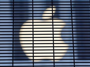The Apple logo is seen through a security fence erected around the Apple Fifth Avenue store as votes continue to be counted following the 2020 U.S. presidential election, in Manhattan, New York City, U.S., November 5, 2020.